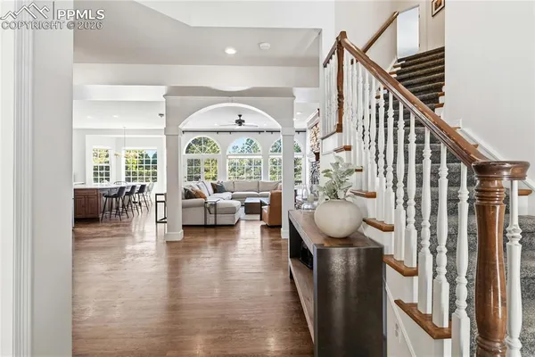 a view of entryway livingroom and hall with wooden floor