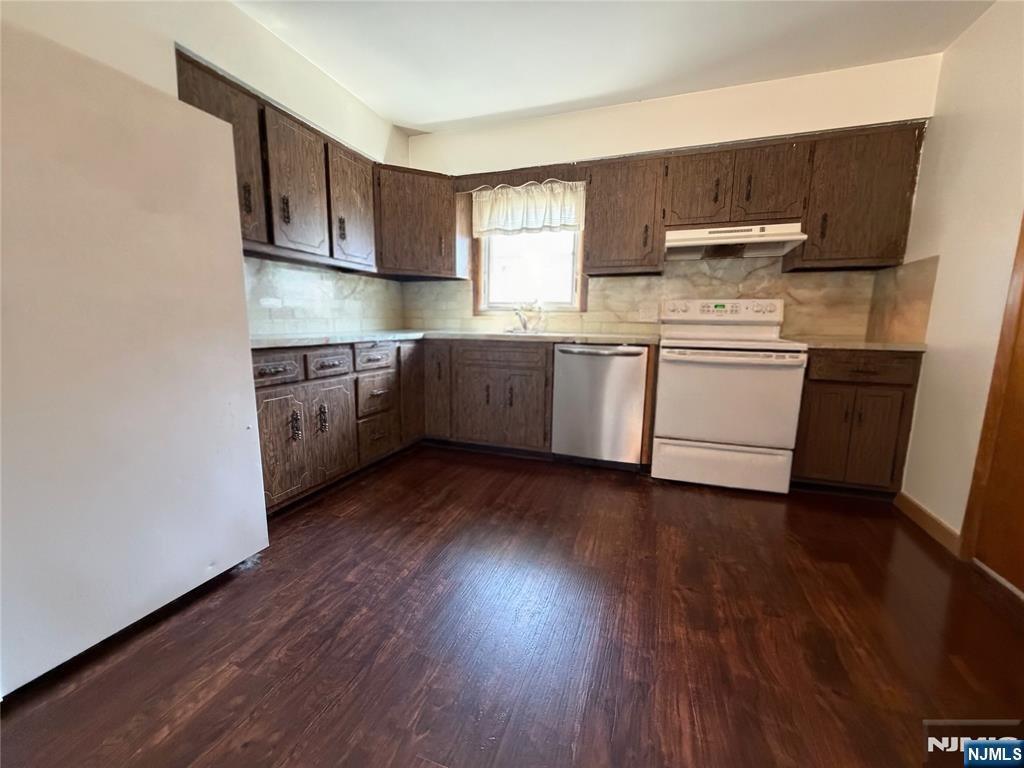 79 Hunter Street Lodi, NJ 07644 - Photo 5 of 11 a kitchen with a sink a stove and cabinets