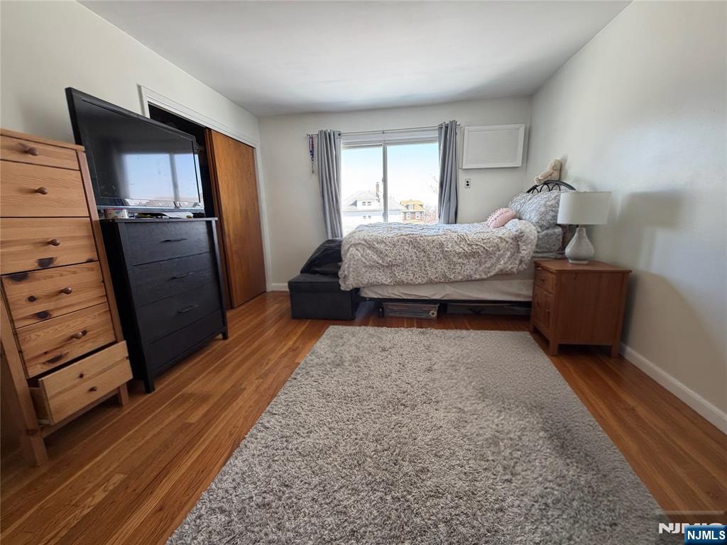 79 Hunter Street Lodi, NJ 07644 - Photo 7 of 11 a bedroom with a bed and wooden floor