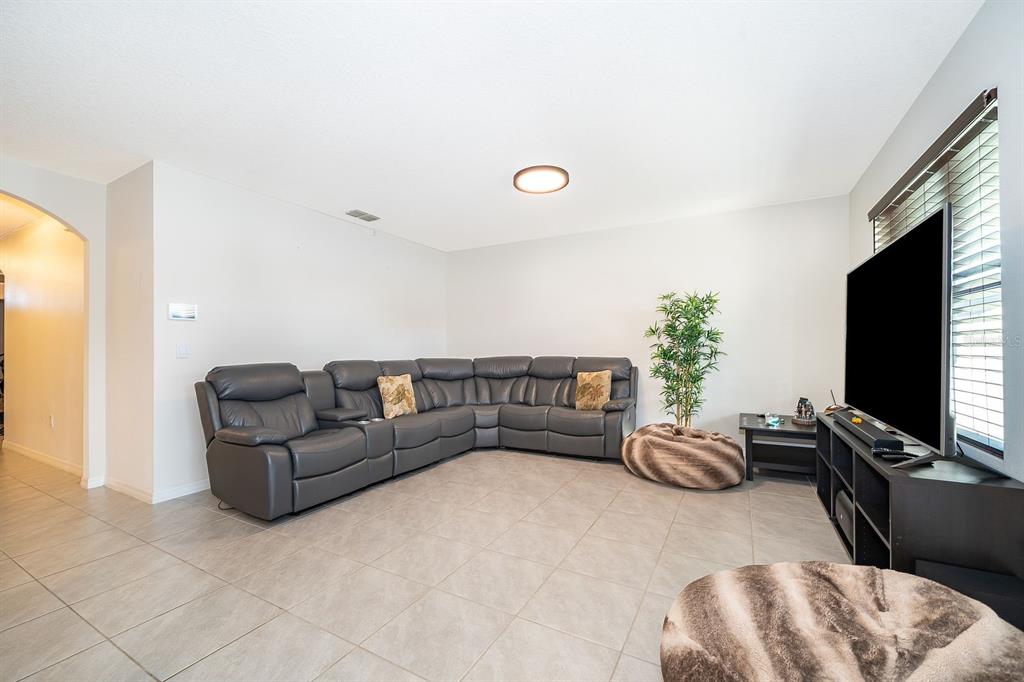2795 Harmonia Hammock Road St. Cloud, FL 34773 - Photo 11 of 30 a living room with furniture and a flat screen tv