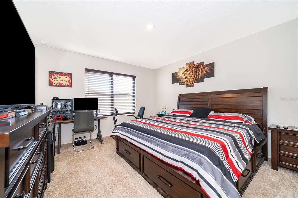 2795 Harmonia Hammock Road St. Cloud, FL 34773 - Photo 13 of 30 a bedroom with a bed and a flat screen tv