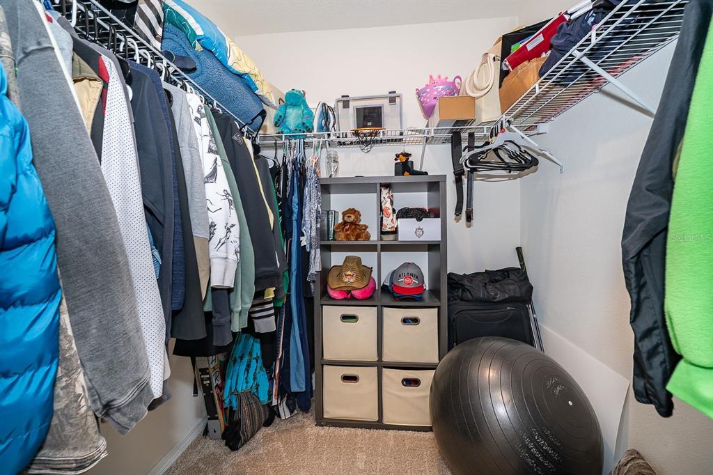 2795 Harmonia Hammock Road St. Cloud, FL 34773 - Photo 14 of 30 a view of walk in closet with clothes and shoes