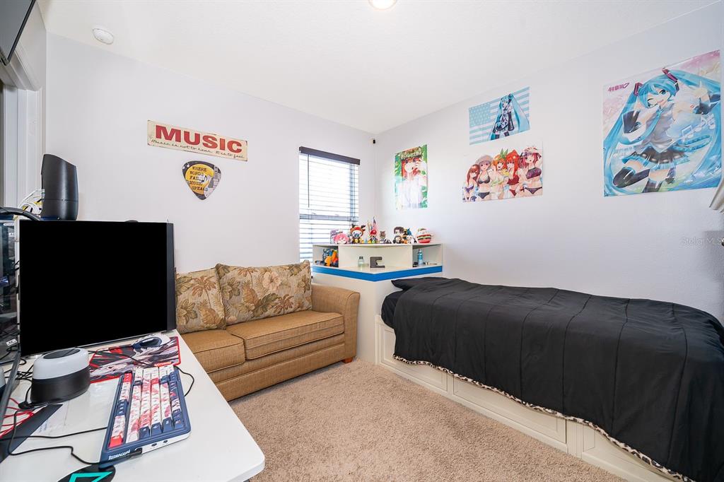 2795 Harmonia Hammock Road St. Cloud, FL 34773 - Photo 18 of 30 a living room with furniture and a flat screen tv