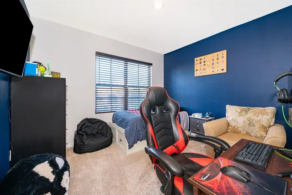 a bedroom with furniture and a window
