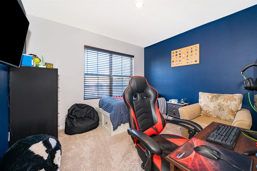 2795 Harmonia Hammock Road St. Cloud, FL 34773 - Photo 19 of 30 a bedroom with furniture and a window