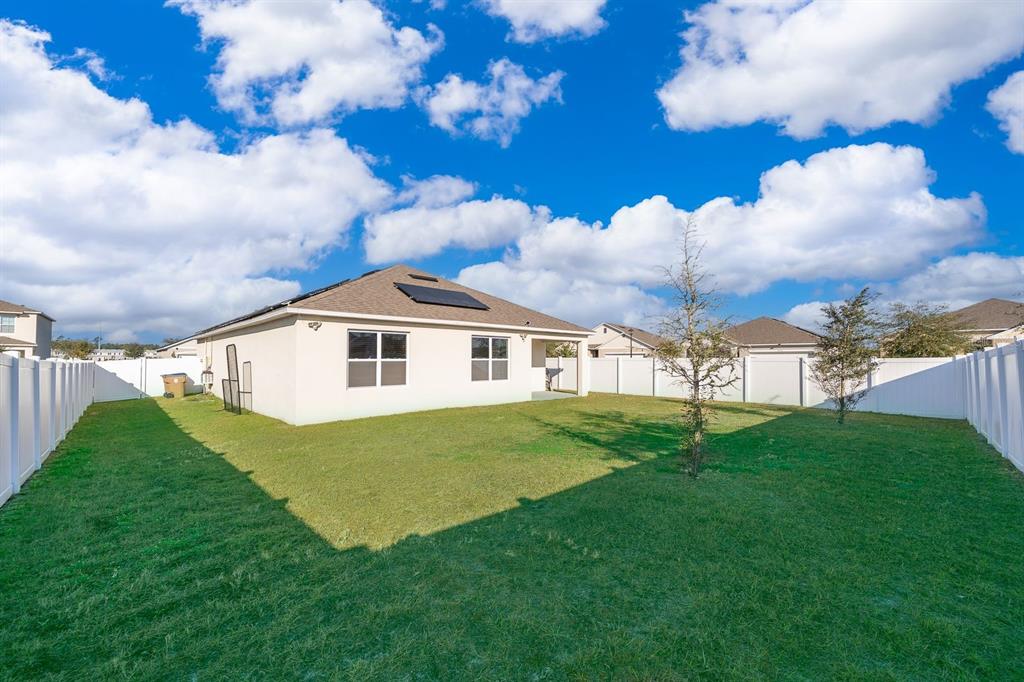 2795 Harmonia Hammock Road St. Cloud, FL 34773 - Photo 24 of 30 a front view of a house with garden