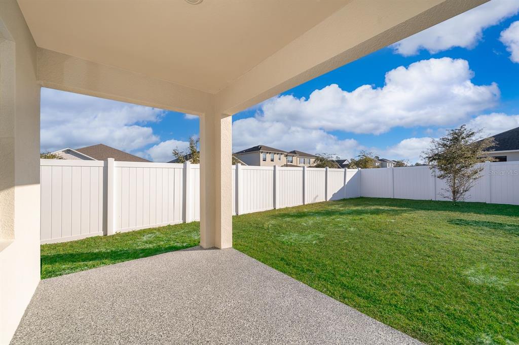 2795 Harmonia Hammock Road St. Cloud, FL 34773 - Photo 25 of 30 a view of a backyard with a garden and entertaining space