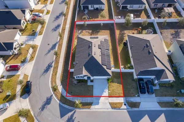 an aerial view of residential houses and outdoor space