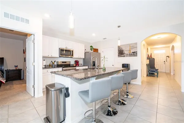 a large kitchen with a table and chairs in it