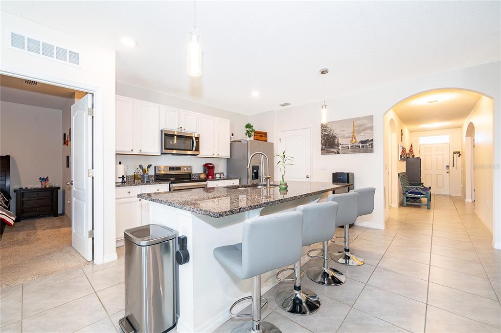 2795 Harmonia Hammock Road St. Cloud, FL 34773 - Photo 8 of 30 a large kitchen with a table and chairs in it