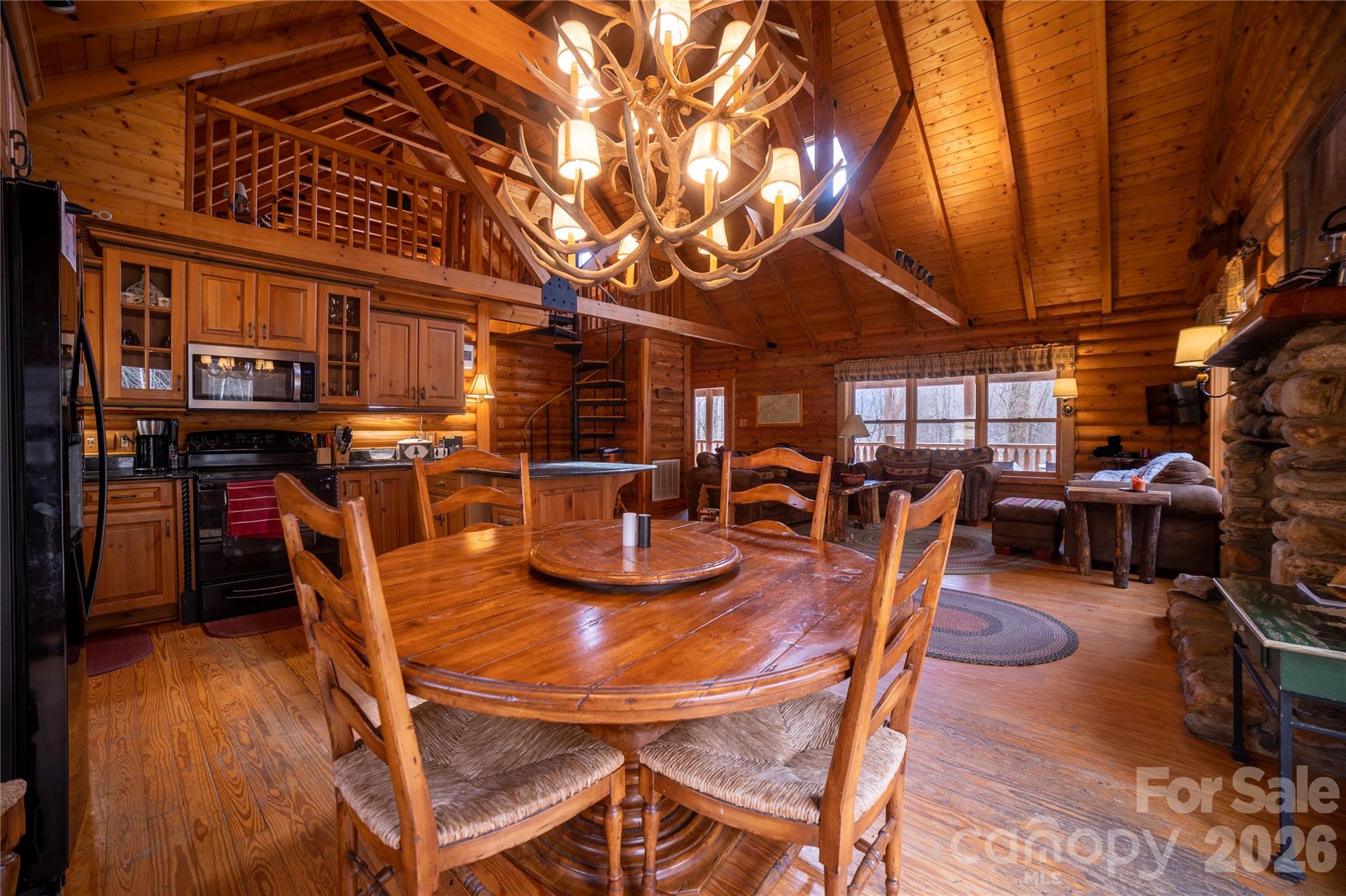 682 Rock House Road Hot Springs, NC 28743 - Photo 11 of 43 a dining room with furniture and wooden floor