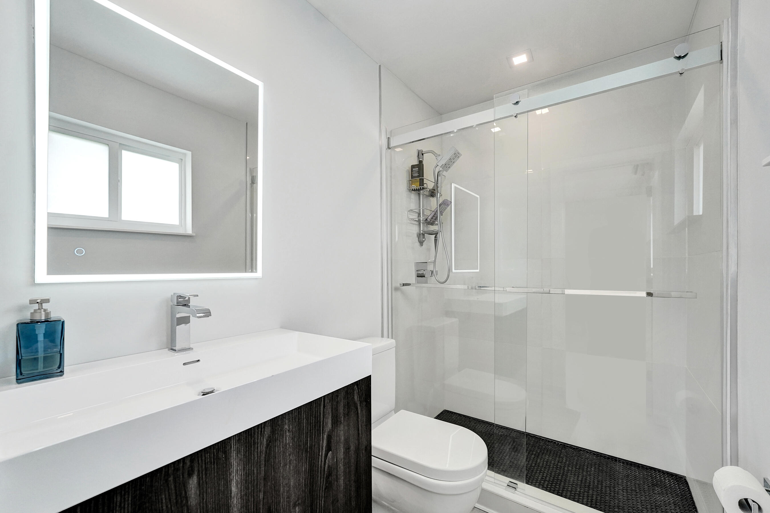381 Southeast 3rd Street Pompano Beach, FL 33060 - Photo 33 of 41 a bathroom with a sink a toilet and shower