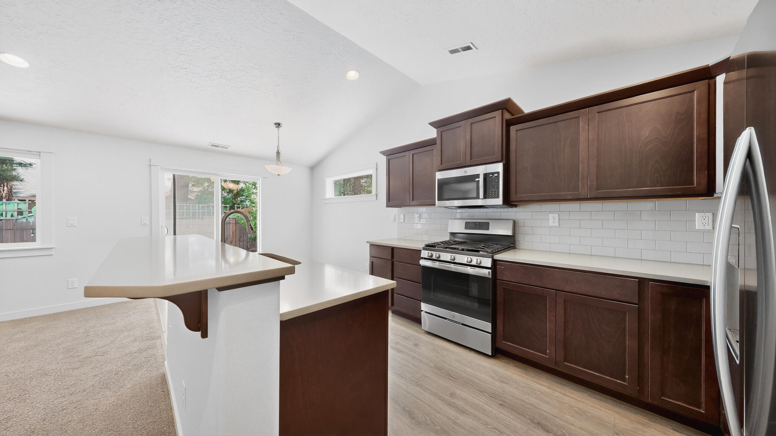 680 McKinney Ranch Road Sisters, OR 97759 - Photo 21 of 41 a kitchen with stainless steel appliances granite countertop a stove refrigerator sink and microwave