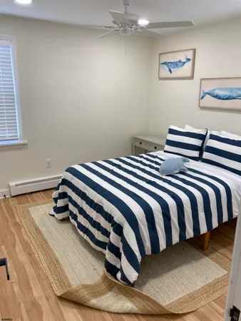 a bedroom with a bed and painting on the wall