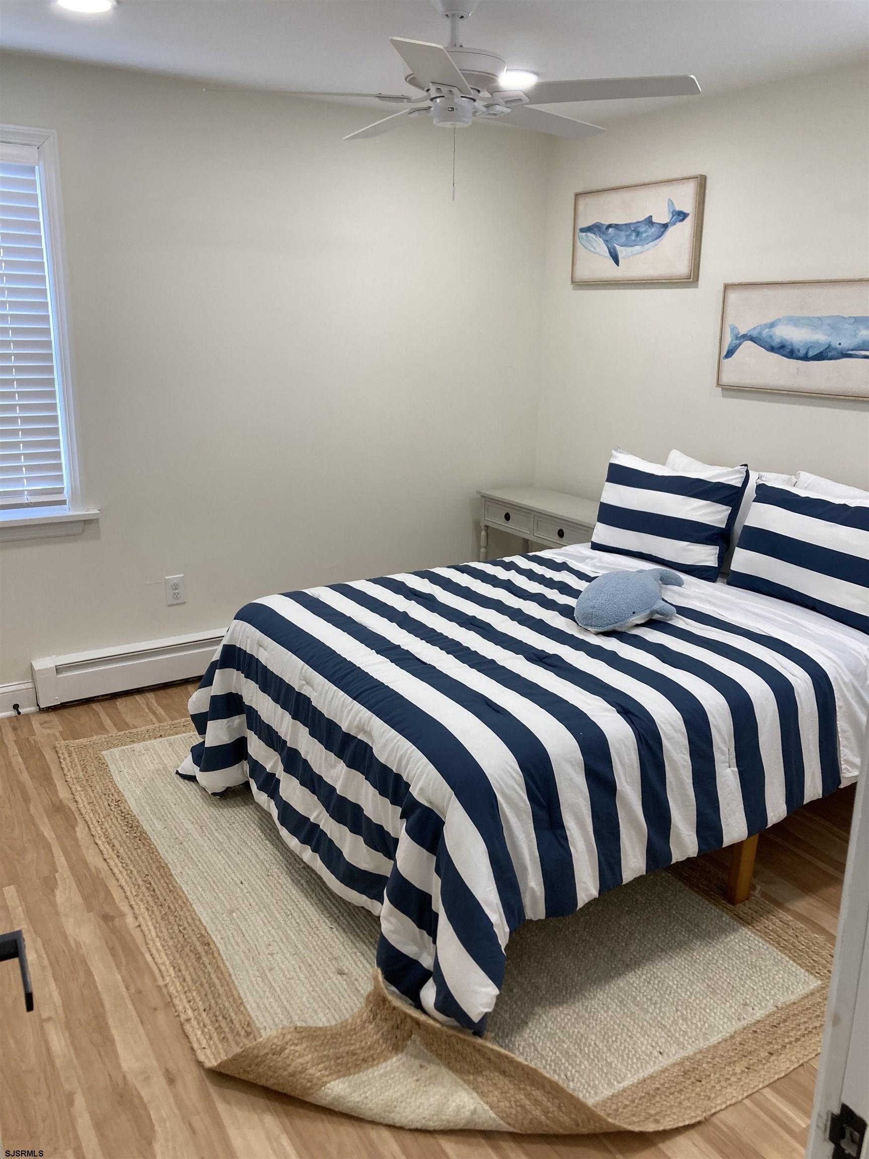 271 38th Street South, Unit A / B Brigantine, NJ 08203 - Photo 6 of 7 a bedroom with a bed and painting on the wall