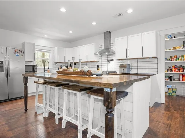 a kitchen with granite countertop a sink appliances cabinets and counter space