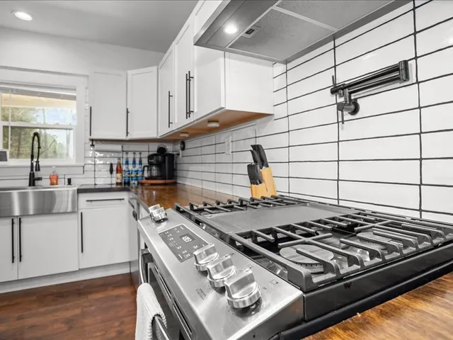 a stove top oven sitting inside of a kitchen