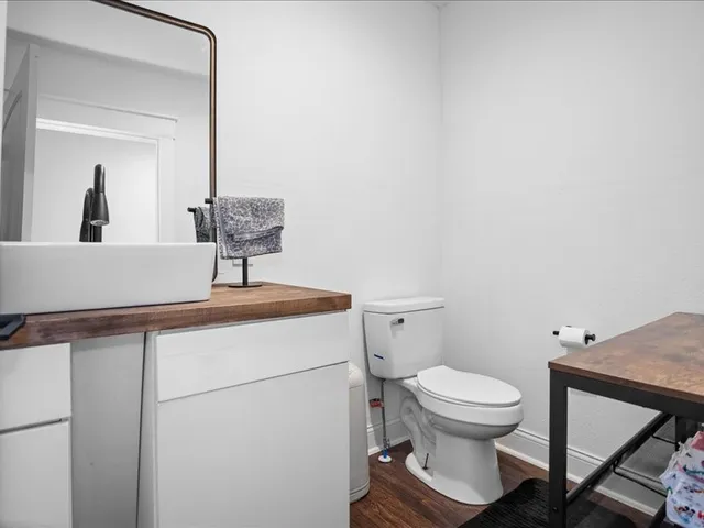 a bathroom with a toilet a sink and mirror