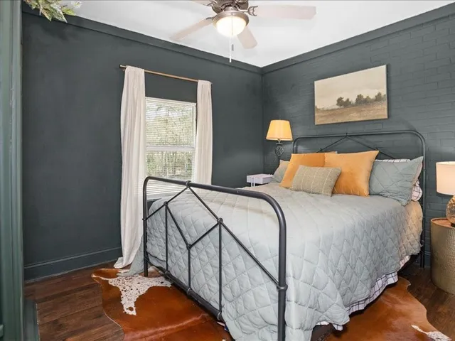 a bedroom with a bed and a window