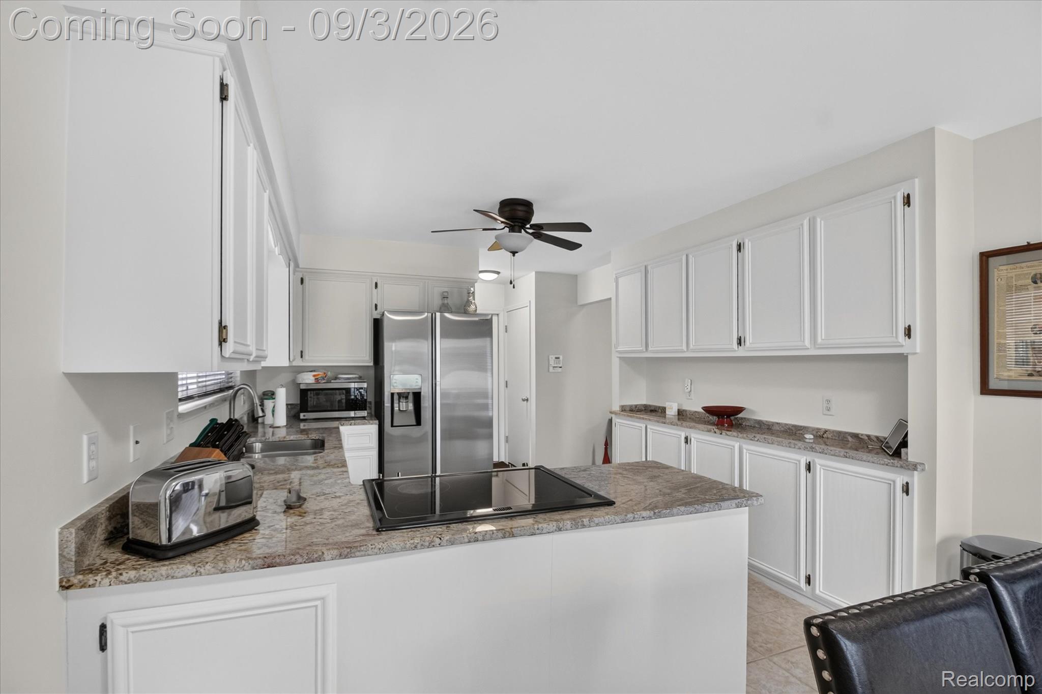 27260 Campbell Road Warren, MI 48093 - Photo 14 of 60 Kitchen featuring white cabinetry, stainless steel refrigerator, integrated stovetop, and granite countertops