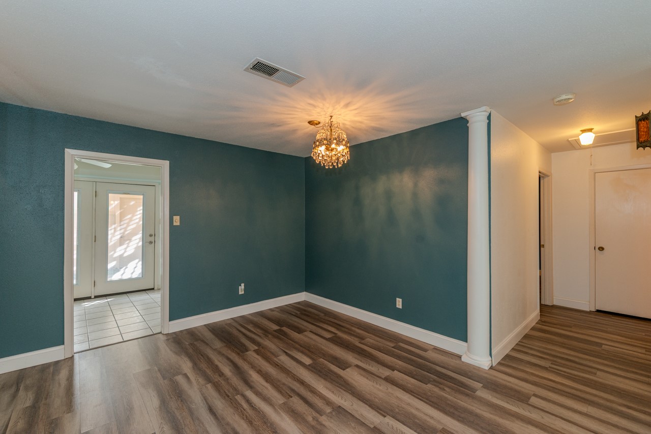 5975 Meadow Way Beaumont, TX 77707 - Photo 4 of 18 a view of empty room with window and wooden floor