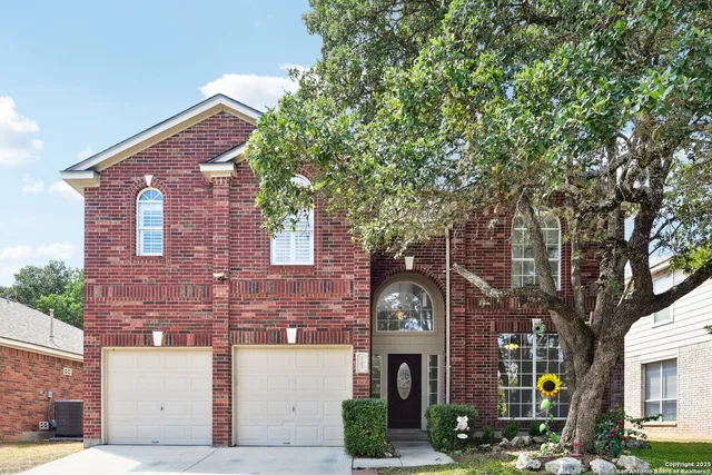 a front view of a building with tree s