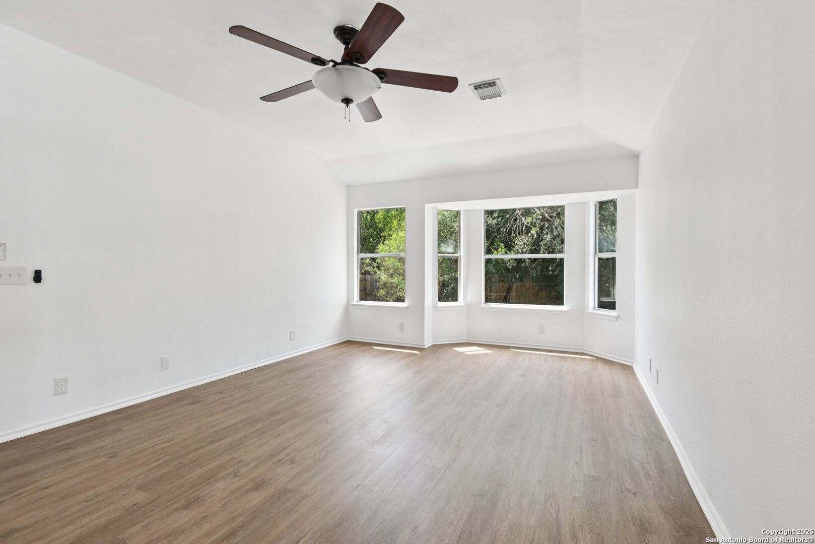 21510 Rio Colorado San Antonio, TX 78259 - Photo 20 of 42 an empty room with wooden floor fan and windows