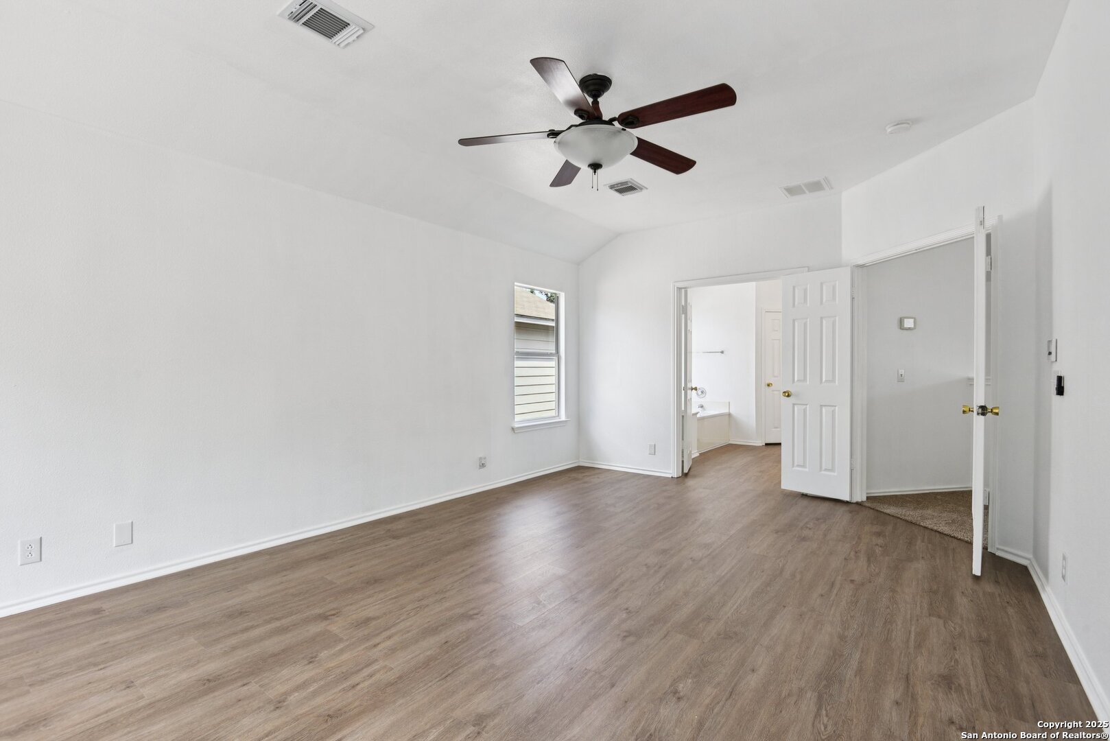 21510 Rio Colorado San Antonio, TX 78259 - Photo 21 of 42 an empty room with wooden floor and a ceiling fan