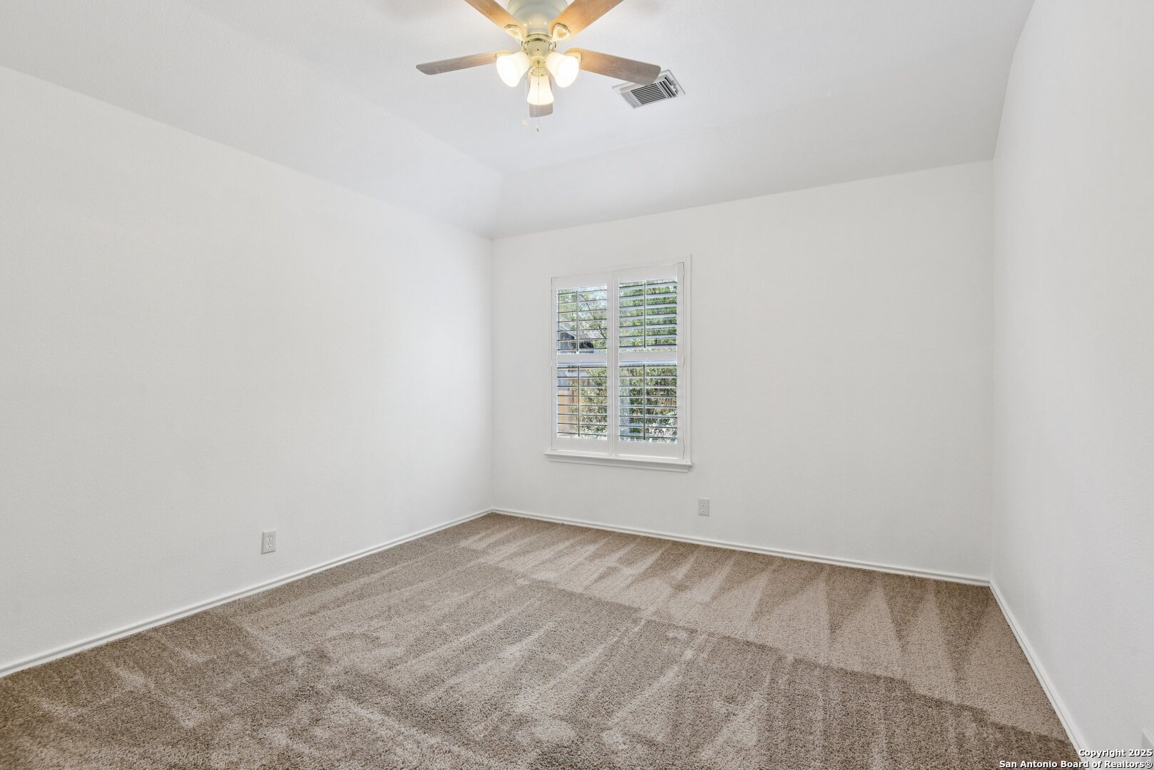 21510 Rio Colorado San Antonio, TX 78259 - Photo 27 of 42 an empty room with a chandelier fan and windows