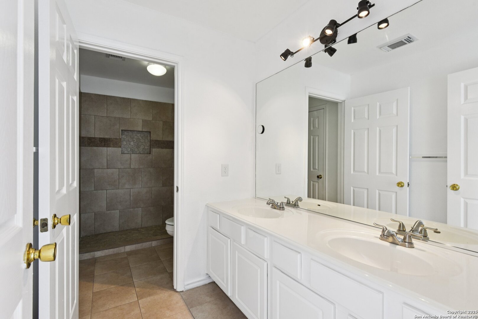 21510 Rio Colorado San Antonio, TX 78259 - Photo 30 of 42 a bathroom with a double vanity sink and mirror