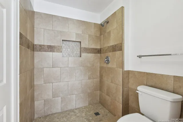 an empty room with a window and a ceiling fan