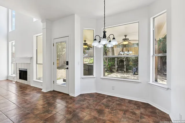 a view of an empty room with a fireplace and a window