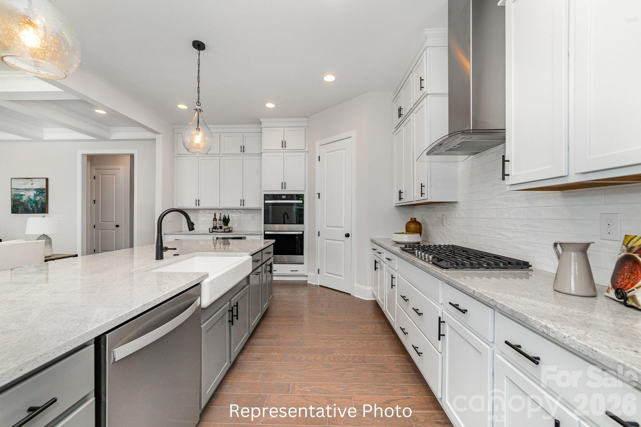 0 Rivendell Road, Unit 40 Denver, NC 28037 - Photo 11 of 23 a large kitchen with stainless steel appliances granite countertop a sink and cabinets