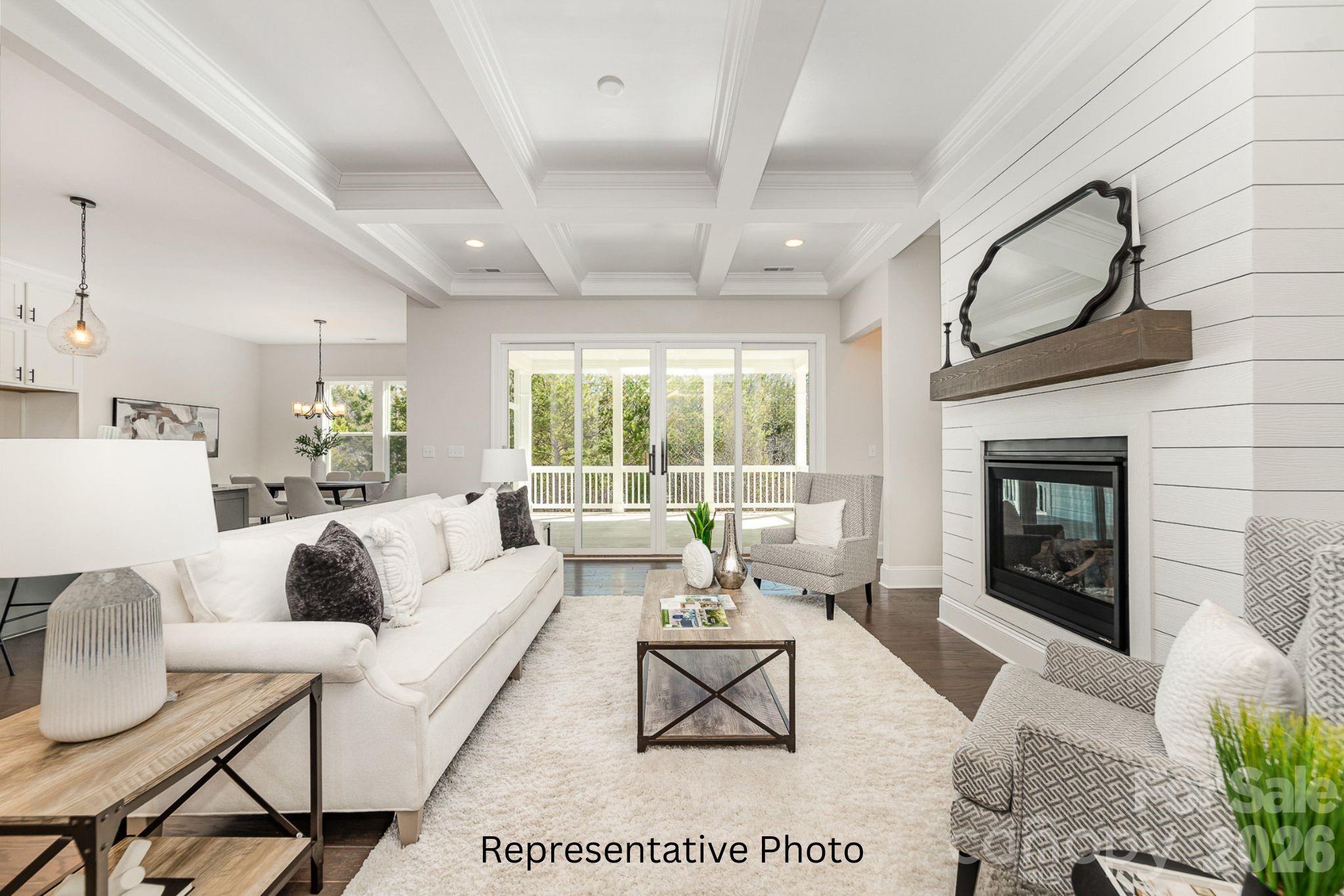 0 Rivendell Road, Unit 40 Denver, NC 28037 - Photo 5 of 23 a living room with furniture a fireplace a rug and a large window