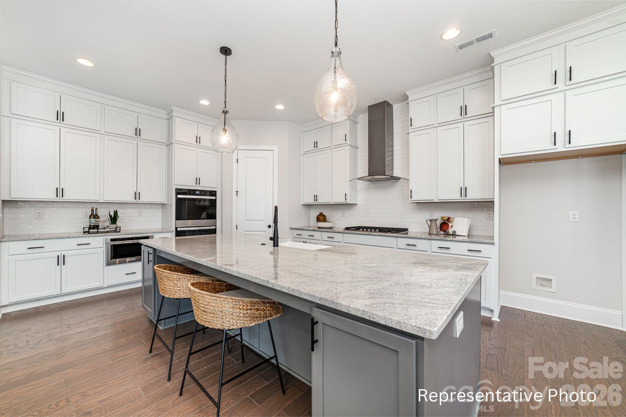 0 Rivendell Road, Unit 40 Denver, NC 28037 - Photo 8 of 23 a kitchen with white cabinets and counter space