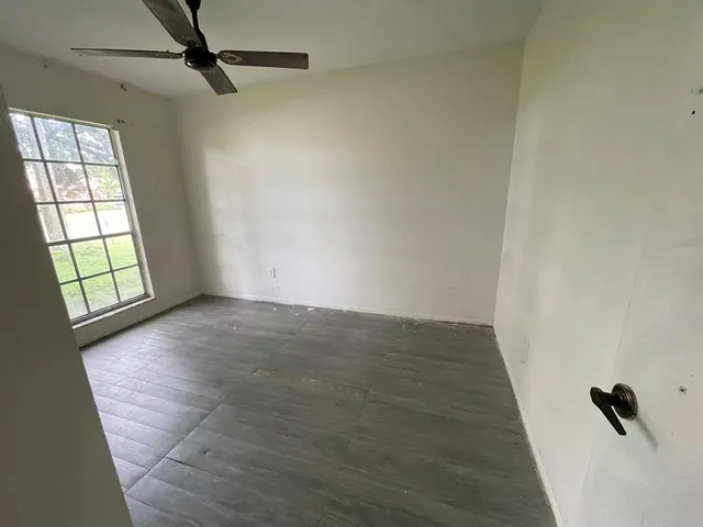 a view of a livingroom with a ceiling fan and window