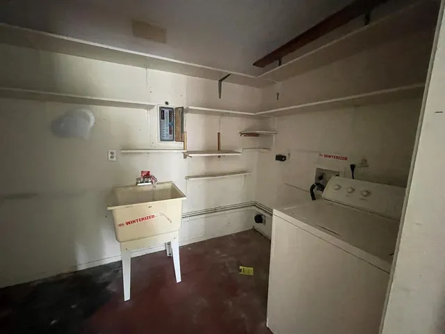 a kitchen with a stove sink and cabinets