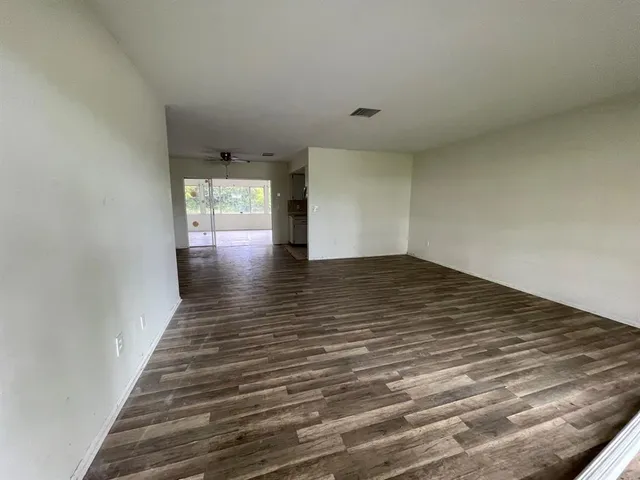 a backyard of a house with plants and large trees