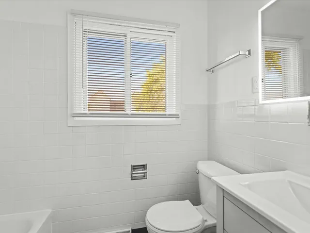 a white toilet sitting next to a bathroom sink
