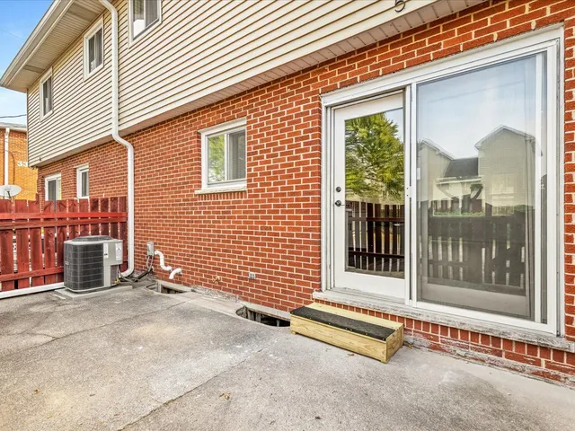 a view of a brick house with a large window