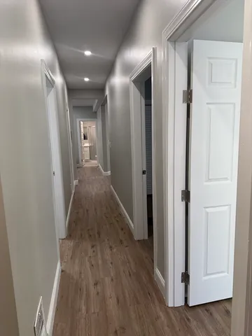 a view of hallway with wooden floor