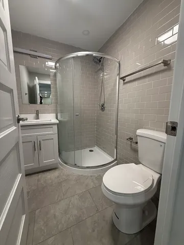 a bathroom with a toilet a sink and shower