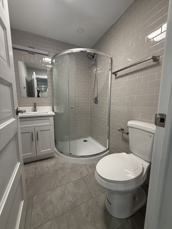 19 Dewolf Street, Unit 1 Boston, MA 02125 - Photo 3 of 12 a bathroom with a toilet a sink and shower