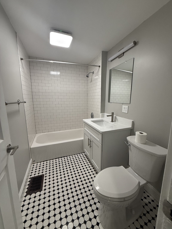 19 Dewolf Street, Unit 1 Boston, MA 02125 - Photo 7 of 12 a bathroom with a sink a toilet a mirror and shower