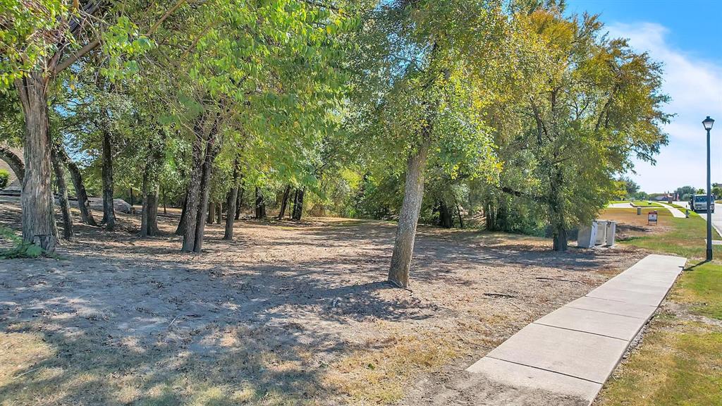 133 Falcon Point Drive Heath, TX 75032 - Photo 2 of 11 a view of a yard with plants and trees