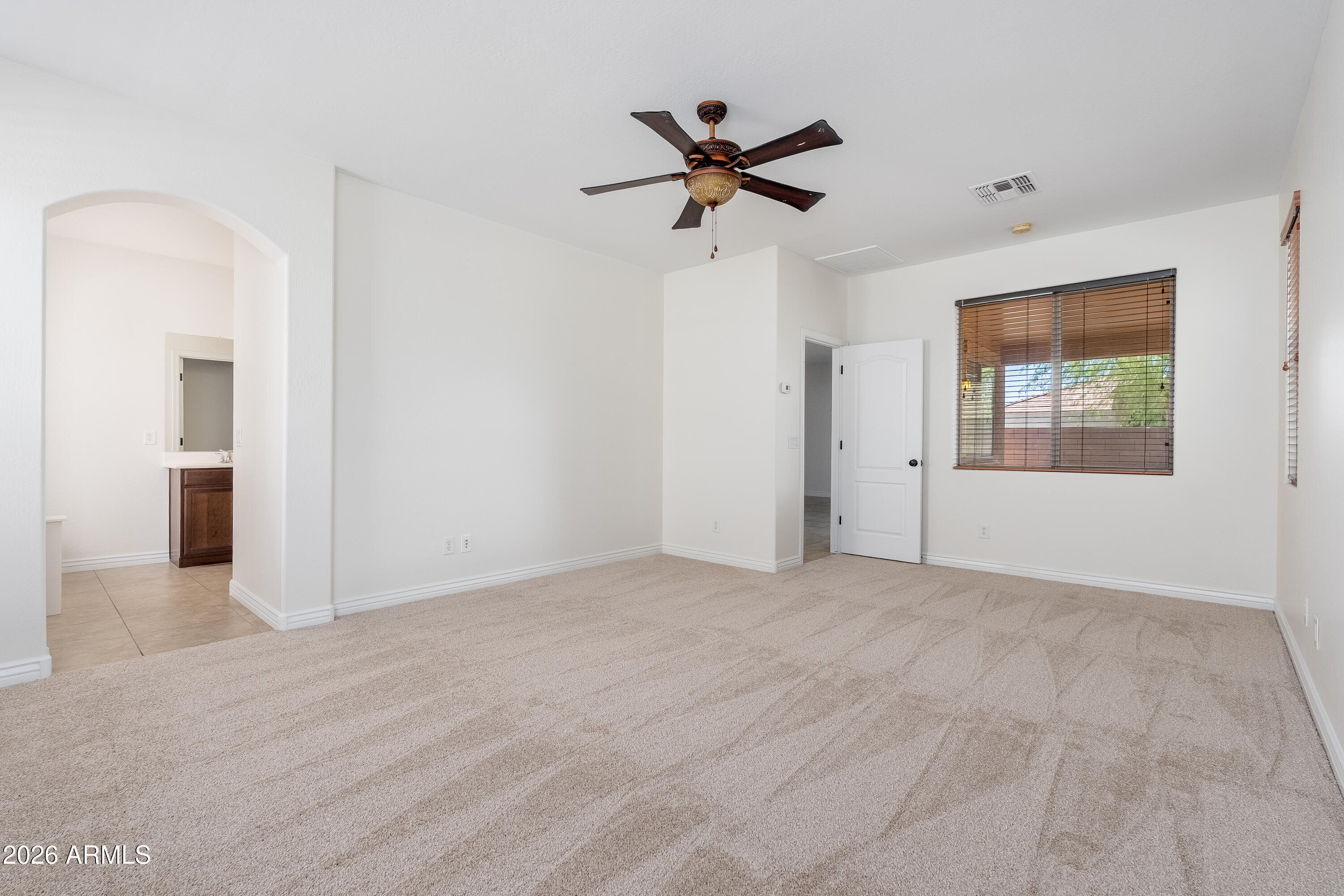 4317 East Folgers Road Phoenix, AZ 85050 - Photo 14 of 40 a view of empty room with wooden floor and ceiling fan