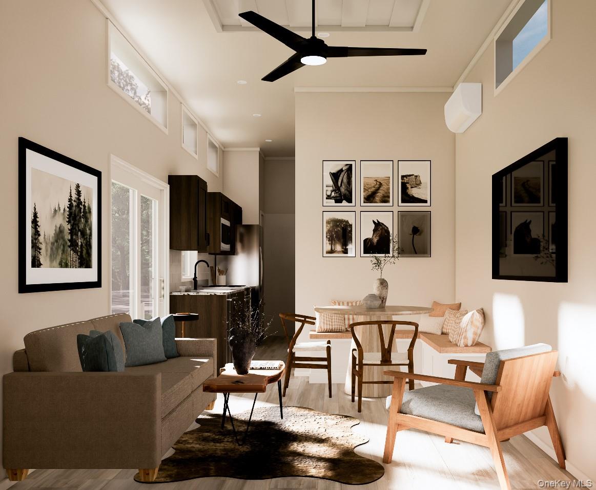 197 Wheeler Road, Unit 90 Florida, NY 10921 - Photo 5 of 37 Living area with a towering ceiling, light wood-type flooring, and a ceiling fan