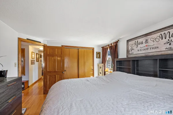 a bedroom with a large bed and a dresser