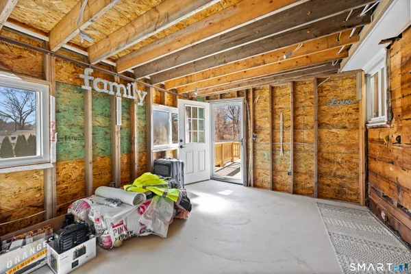 a bedroom with furniture and large windows