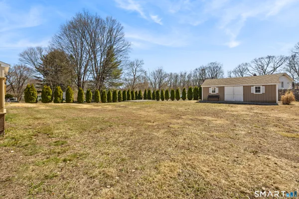 a big house with a big yard and large trees